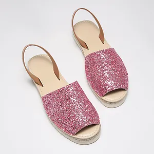 Detailed top view of pink glitter peep-toe flat sandals with comfortable backstrap