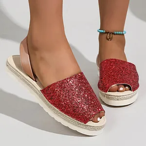 Detailed view of red glitter peep-toe sandals with a stylish jute-wrapped platform sole