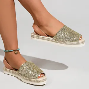 Detailed view of women's gold glitter peep-toe sandals with platform braided rope sole