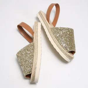 Detailed view of gold glitter flat sandals with comfortable soft sole design