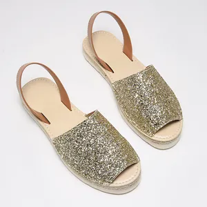 Sparkling gold sequin peep-toe flat sandals featuring a comfortable slingback strap