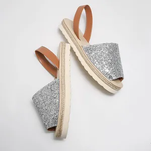 Elegant silver glitter flat sandals for women featuring open toe and soft jute sole