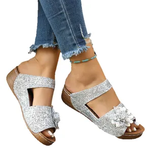Sparkly silver glitter wedge sandals with floral accent and open-toe design for women