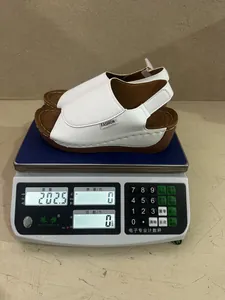 White wedge sandal weighed on a digital scale showing 202.5g for lightweight comfort