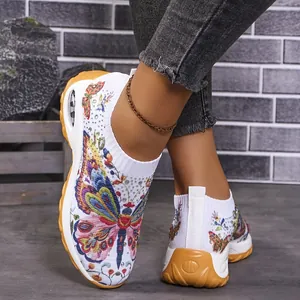 Vue détaillée de baskets blanches en fly-knit avec imprimé papillon et strass.