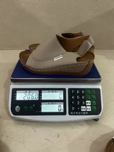 Close-up of a lightweight women's wedge sandal weighing 206.0 grams on a digital scale.