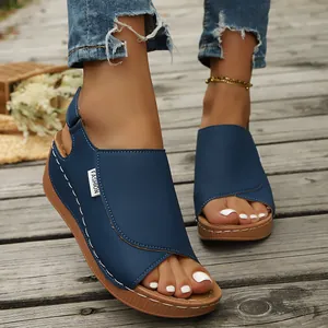 Detail of blue women's wedge sandals with thick platform and stylish stitching detail