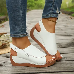 Close-up of stylish white wedge platform sandals for women on a wooden path