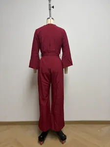 Detailed back view of a wine red long-sleeved wide-leg jumpsuit on a tailor mannequin