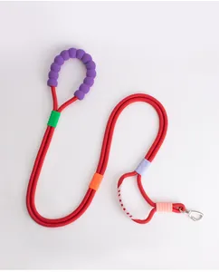 Detail of a red heavy-duty dog training leash featuring a comfortable purple beaded handle