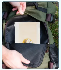 Close-up detail of thickened eco-friendly pet waste bags stored inside a green backpack pocket