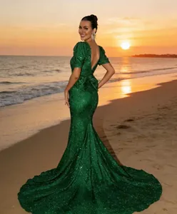 Detailed view of emerald green sequin evening gown with V-neck and lantern sleeves