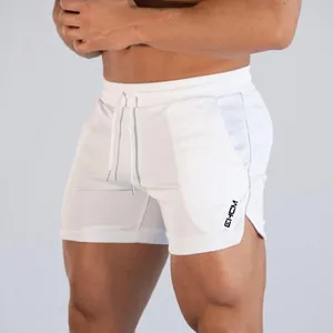Detail view of white quick-dry gym shorts for men featuring a side slit design