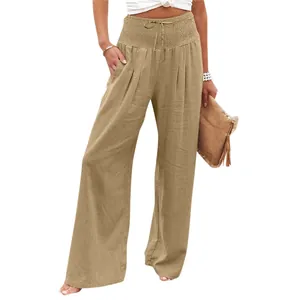 Detailed view of women's high-waisted smocked wide-leg trousers in khaki linen blend