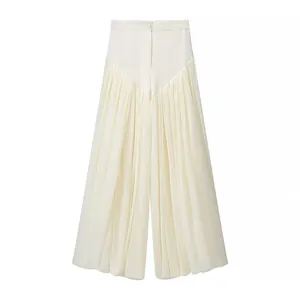 Detailed macro view of cream high-waisted lantern trousers featuring elegant pleats