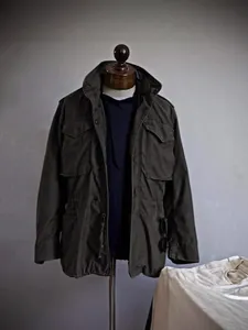 Vintage men's heavy cotton military field jacket with multi-pocket workwear design