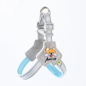 Close-up of light blue dog harness with reflective stitching and cartoon patch