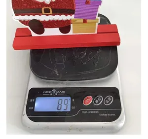 Close-up detail of 89g wooden Christmas Santa Claus decoration set on a digital scale