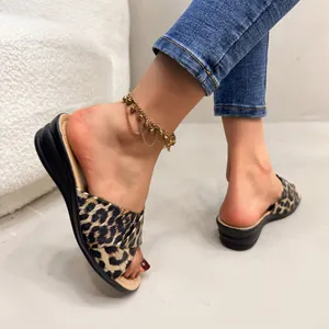 Detail view showing women's leopard print wedge sandals with a stylish fish toe design