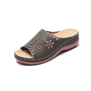 Detailed view of stylish women's floral cutout peep-toe wedge sandals with platform sole