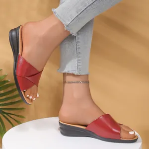 Elegant red leather wedge sandals for women with peep-toe design and comfortable heel.