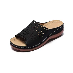 Black women's wedge sandals with laser-cut floral pattern and peep-toe design for summer