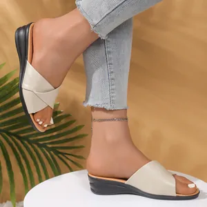 Elegant off-white wedge sandals for women with cross-over straps and open-toe design.