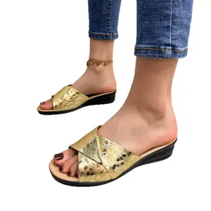 Women's elegant metallic gold wedge sandals featuring a stylish peep toe design