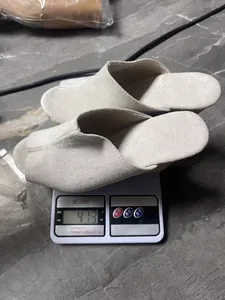Off-white suede peep-toe wedge sandals on a scale showing weight measurement of 413g