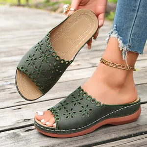Detail of green women's peep-toe wedge sandals with floral embroidery and thick sole