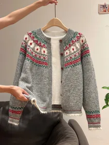 Detail view of the intricate vintage Fair Isle pattern on a soft gray knit cardigan