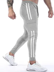 Detailed side view of grey men's cargo joggers with double white stripes and ribbed cuffs.