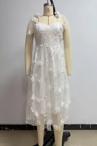 Detailed view of white v-neck camisole dress with delicate floral embroidery and tulle skirt