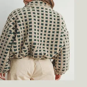 Close-up back view of a women's checkered sherpa fleece jacket in green and beige