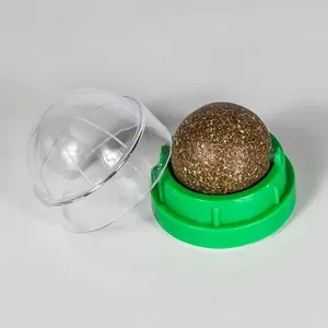 Detail view of a catnip ball toy featuring a rotating herb ball with a green base and clear cover