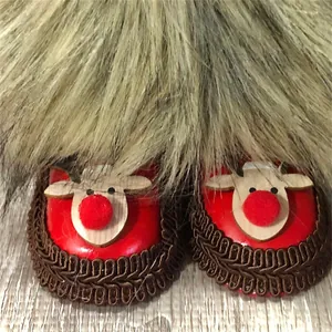 Detailed macro view showing the reindeer pattern shoes of a Christmas faceless gnome doll