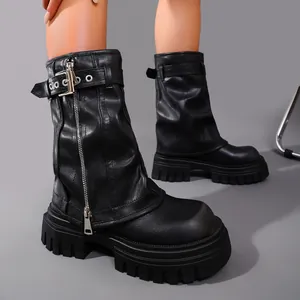 Detail view of stylish black leather platform biker boots with metallic buckle and zipper