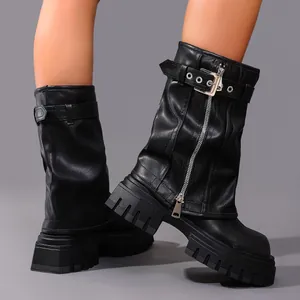 Detail view of black leather platform slouchy moto boots with buckle and zipper strap.