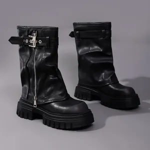 Detailed view of black leather mid-calf boots with chunky platform and buckle strap