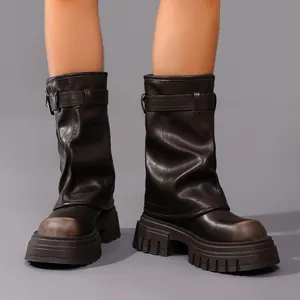 Macro view showing the square toe and thick platform sole of dark brown leather boots