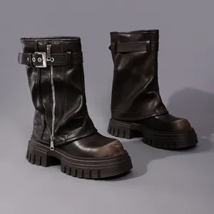 Close-up detail of dark brown leather biker boots featuring square toe and chunky platform