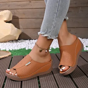 Stylish summer brown wedge sandals featuring laser-cut patterns and peep-toe design for women