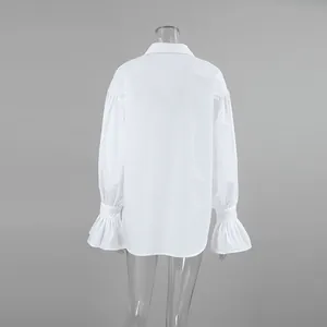 Back view of a white cotton French-style shirt with elegant flared bell cuffs for women