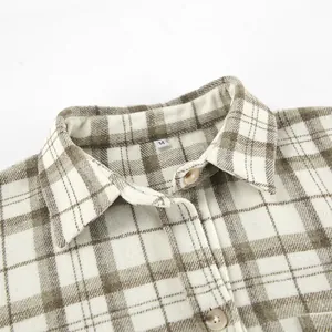 Detail view of a vintage plaid shirt collar featuring a classic brown check pattern.