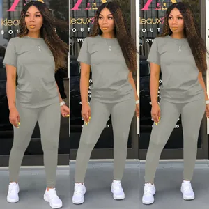 Front view of grey two-piece tracksuit set with short sleeve t-shirt and leggings