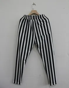 Back view of men's black and white vertically striped sports pants with pocket detail