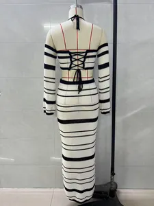 Back view of a black and white striped knit halter top and maxi skirt set on a mannequin