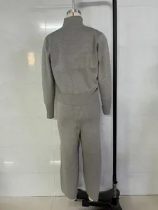 Back view of grey knitted long-sleeve cardigan and straight trousers set for women