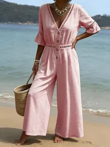 Elegant pink V-neck wide-leg jumpsuit with delicate lace short sleeves for summer beach vacation