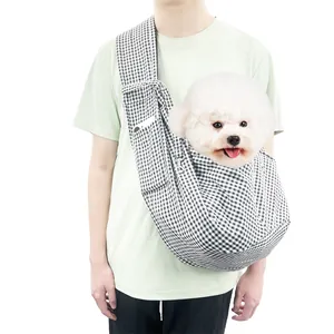 Detail view of houndstooth pet sling carrier showing a dog inside for size scale